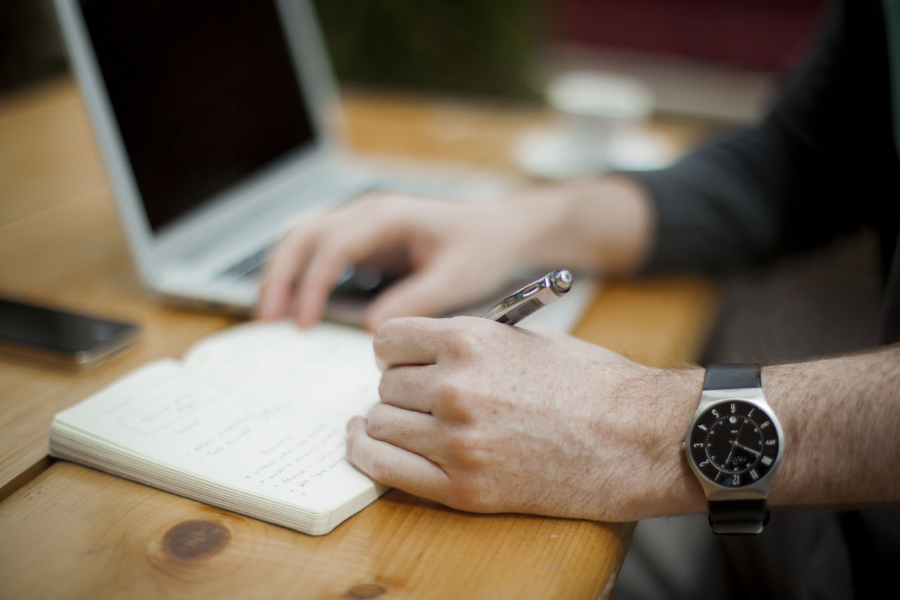 woman-hand-smartphone-desk